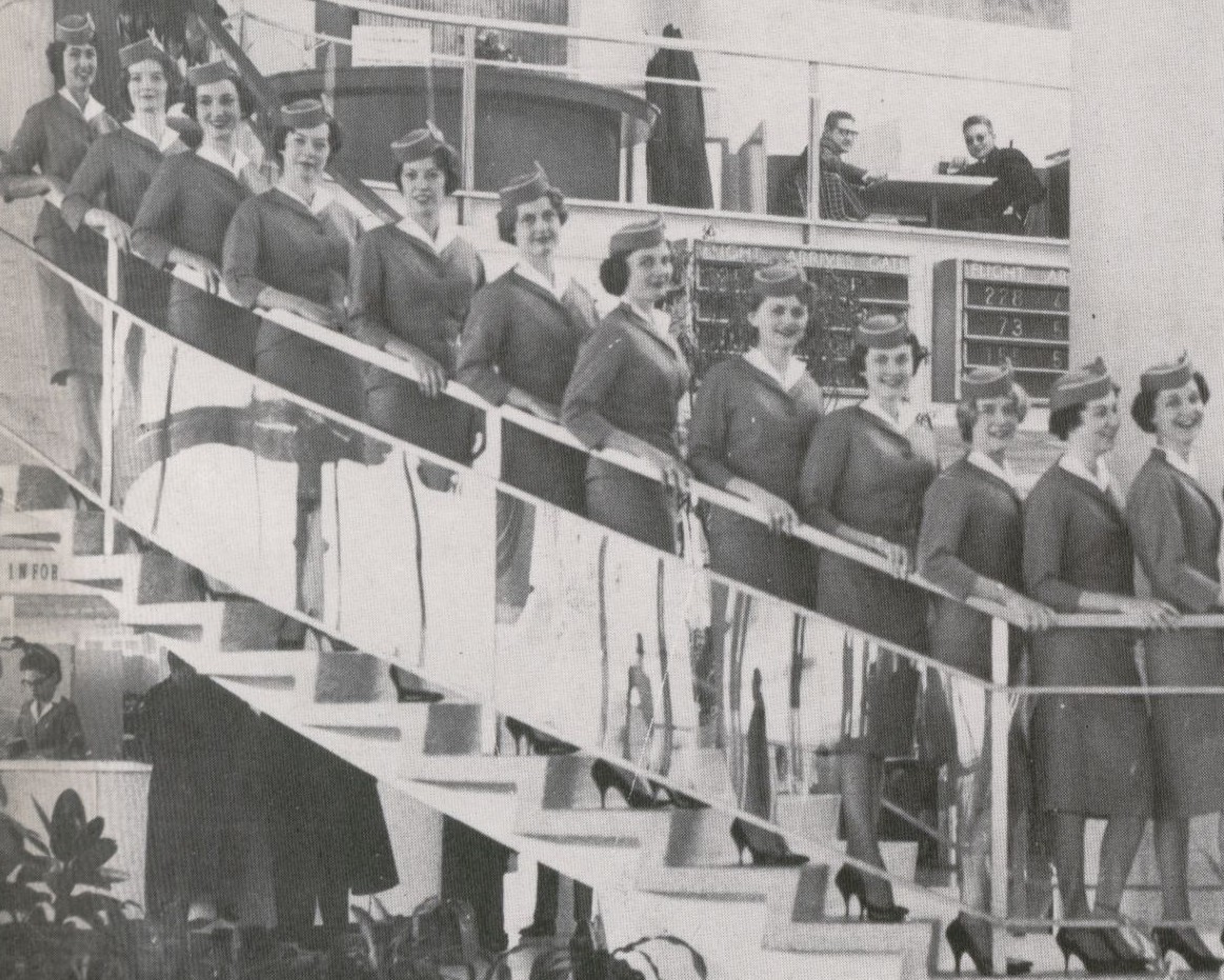 1959 A group of new Stewardesses pose on the steps of the Pan Am WorldPort at JFK Airport.